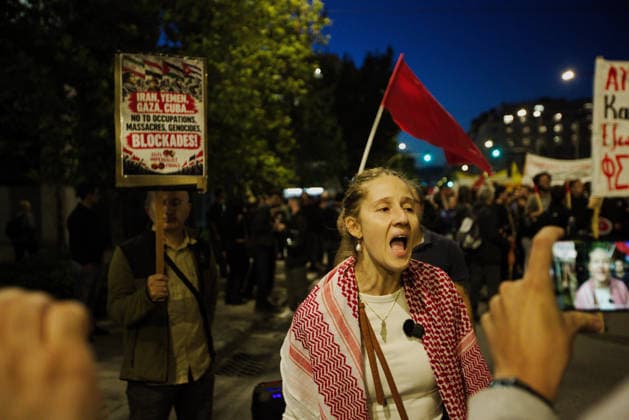 October 6, 2026, Athens, Attica, GREECE: A protester wearing a Palestinian keffiyeh is being interviewed during an anti-war demonstration opposing the visit of US Secretary of State MARCO RUBIO. Athens GREECE - ZUMAx103 20261006_zip_x103_020 Copyright: xHarrisxXanthopoulosx