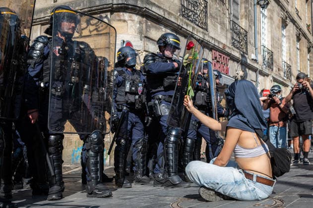 October 6, 2026, Bordeaux, Nouvelle-Aquitaine, France: Seated on the ground in front of mobile gendarmes, a young high school student offers them a rose during the demonstration in Bordeaux. Bordeaux France  - ZUMAh207 20261006_zip_h207_002 Copyright: xFabricexHebertx