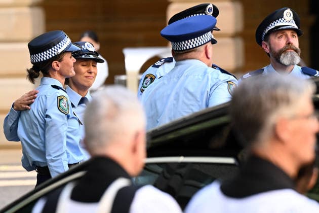 MIA LAY FUNERAL, Police officers comfort each other following the funeral service for NSW Police Constable Mia Lay at St Andrew s Cathedral, in Sydney, Wednesday, October 7, 2026. Constable Mia Lay, 20, died when the marked vehicle she was a passenger in crashed into a tree early on September 25 in the Sydney suburb of Redfern. ( NO ARCHIVING SYDNEY NEW SOUTH WALES Australia  Copyright: xDANxHIMBRECHTSx 20261007190091816813