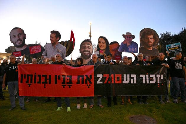 Families and supporters hold placards of faces of Israelis murdered by Hamas during a protest on the third anniversary of the deadliest day in Israel s history outside the Israeli Knesset, Parliament, in Jerusalem, on Wednesday, October 7, 2026. Demonstrators demand a state independent inquiry into the government s security failures, a request rejected by Israeli Prime Minister Benjamin Netanyahu. The banner reads The people shall remember their sons and daughters who were murdered a reference to the Yizkor prayer, with the date 27 10, the day of the upcoming general elections in Israel that are seen as a referendum on Netanyahu s power.  JER2026100703 DEBBIExHILL