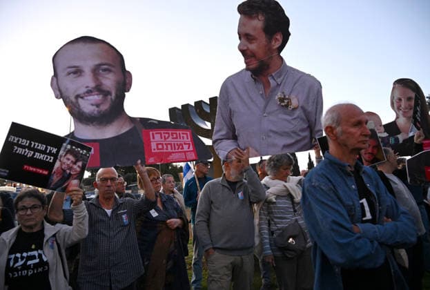 Families and supporters hold placards of faces of Israelis murdered by Hamas during a protest on the third anniversary of the deadliest day in Israel s history outside the Israeli Knesset, Parliament, in Jerusalem, on Wednesday, October 7, 2026. Demonstrators demand a state independent inquiry into the government s security failures, a request rejected by Israeli Prime Minister Benjamin Netanyahu. The banner reads The people shall remember their sons and daughters who were murdered a reference to the Yizkor prayer, with the date 27 10, the day of the upcoming general elections in Israel that are seen as a referendum on Netanyahu s power.  JER2026100705 DEBBIExHILL