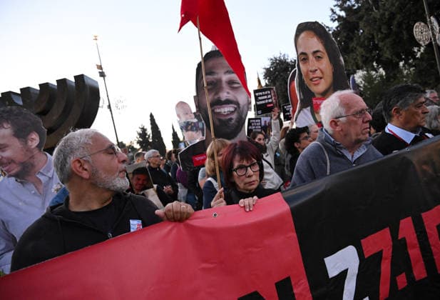 Families and supporters hold placards of faces of Israelis murdered by Hamas during a protest on the third anniversary of the deadliest day in Israel s history outside the Israeli Knesset, Parliament, in Jerusalem, on Wednesday, October 7, 2026. Demonstrators demand a state independent inquiry into the government s security failures, a request rejected by Israeli Prime Minister Benjamin Netanyahu. The banner reads The people shall remember their sons and daughters who were murdered a reference to the Yizkor prayer, with the date 27 10, the day of the upcoming general elections in Israel that are seen as a referendum on Netanyahu s power.  JER2026100706 DEBBIExHILL