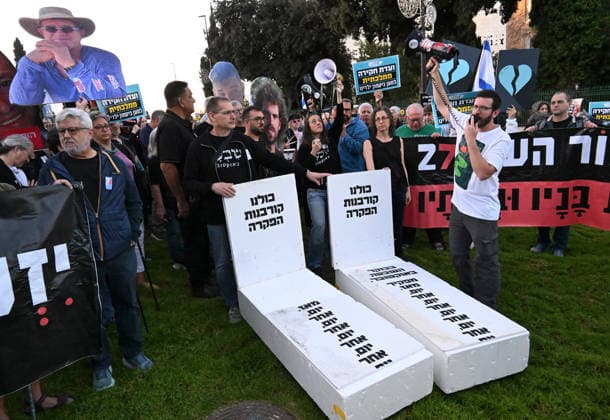 Families and supporters hold placards of faces of Israelis murdered by Hamas with mock coffins during a protest on the third anniversary of the deadliest day in Israel s history outside the Israeli Knesset, Parliament, in Jerusalem, on Wednesday, October 7, 2026. Demonstrators demand a state independent inquiry into the government s security failures, a request rejected by Israeli Prime Minister Benjamin Netanyahu. The banner reads The people shall remember their sons and daughters who were murdered a reference to the Yizkor prayer, with the date 27 10, the day of the upcoming general elections in Israel that are seen as a referendum on Netanyahu s power.  JER2026100709 DEBBIExHILL