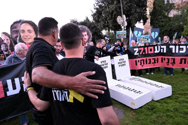 Families and supporters hold placards of faces of Israelis murdered by Hamas with mock coffins during a protest on the third anniversary of the deadliest day in Israel s history outside the Israeli Knesset, Parliament, in Jerusalem, on Wednesday, October 7, 2026. Demonstrators demand a state independent inquiry into the government s security failures, a request rejected by Israeli Prime Minister Benjamin Netanyahu. The banner reads The people shall remember their sons and daughters who were murdered a reference to the Yizkor prayer, with the date 27 10, the day of the upcoming general elections in Israel that are seen as a referendum on Netanyahu s power.  JER2026100710 DEBBIExHILL