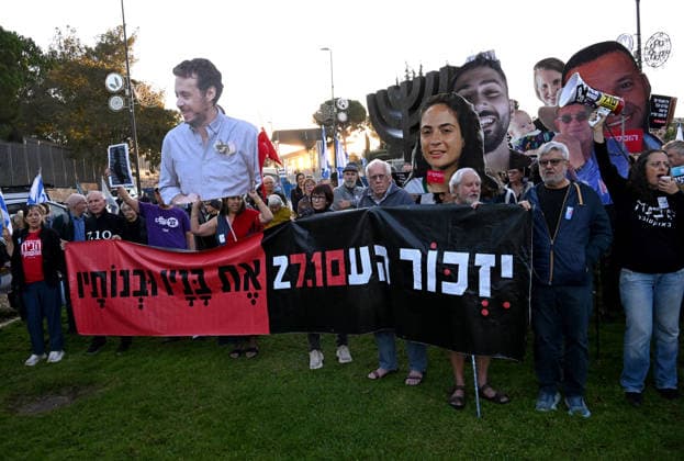 Families and supporters hold placards of faces of Israelis murdered by Hamas during a protest on the third anniversary of the deadliest day in Israel s history outside the Israeli Knesset, Parliament, in Jerusalem, on Wednesday, October 7, 2026. Demonstrators demand a state independent inquiry into the government s security failures, a request rejected by Israeli Prime Minister Benjamin Netanyahu. The banner reads The people shall remember their sons and daughters who were murdered a reference to the Yizkor prayer, with the date 27 10, the day of the upcoming general elections in Israel that are seen as a referendum on Netanyahu s power.  JER2026100714 DEBBIExHILL