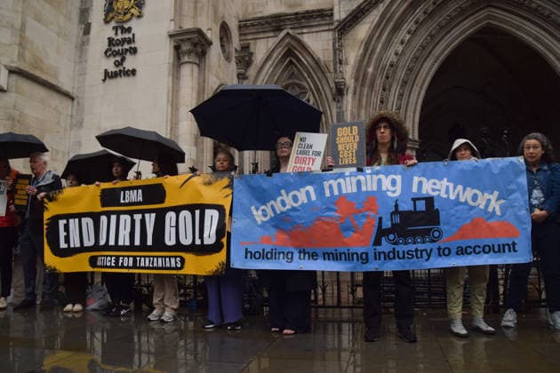 October 7, 2026, London, England, United Kingdom: Campaigners stand outside the Royal Courts of Justice as the legal case against the London Bullion Market Association begins. The LBMA is accused of incorrectly certifying gold from TanzaniaÃ¢â‚¬â ¢s North Mara mine as clean , despite reported human rights abuses connected to the mine. The case is being brought by the families of two Tanzanian men who were killed at the gold mine. London United Kingdom - ZUMAv130 20261007_zip_v130_001 Copyright: xVukxValcicx
