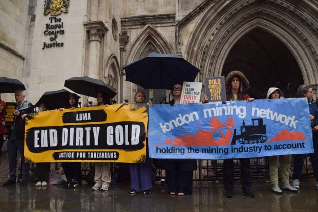 October 7, 2026, London, England, United Kingdom: Campaigners stand outside the Royal Courts of Justice as the legal case against the London Bullion Market Association begins. The LBMA is accused of incorrectly certifying gold from TanzaniaÃ¢â‚¬â ¢s North Mara mine as clean , despite reported human rights abuses connected to the mine. The case is being brought by the families of two Tanzanian men who were killed at the gold mine. London United Kingdom - ZUMAv130 20261007_zip_v130_003 Copyright: xVukxValcicx