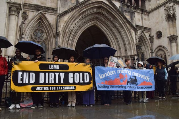 October 7, 2026, London, England, United Kingdom: Campaigners stand outside the Royal Courts of Justice as the legal case against the London Bullion Market Association begins. The LBMA is accused of incorrectly certifying gold from TanzaniaÃ¢â‚¬â ¢s North Mara mine as clean , despite reported human rights abuses connected to the mine. The case is being brought by the families of two Tanzanian men who were killed at the gold mine. London United Kingdom - ZUMAv130 20261007_zip_v130_004 Copyright: xVukxValcicx