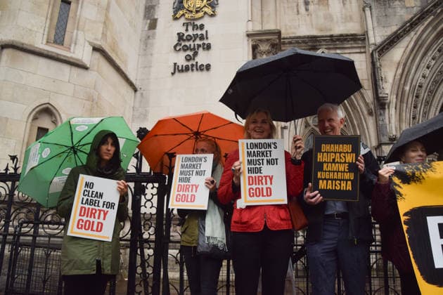 October 7, 2026, London, England, United Kingdom: Campaigners stand outside the Royal Courts of Justice as the legal case against the London Bullion Market Association begins. The LBMA is accused of incorrectly certifying gold from TanzaniaÃ¢â‚¬â ¢s North Mara mine as clean , despite reported human rights abuses connected to the mine. The case is being brought by the families of two Tanzanian men who were killed at the gold mine. London United Kingdom - ZUMAv130 20261007_zip_v130_002 Copyright: xVukxValcicx
