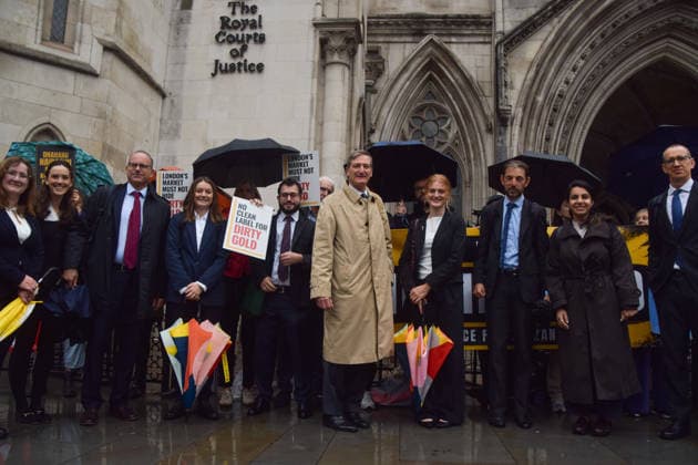 October 7, 2026, London, England, United Kingdom: Barrister and former Attorney General DOMINIC GRIEVE KC (centre) stands with the legal team and campaigners outside the Royal Courts of Justice as the legal case against the London Bullion Market Association begins. The LBMA is accused of incorrectly certifying gold from TanzaniaÃ¢â‚¬â ¢s North Mara mine as clean , despite reported human rights abuses connected to the mine. The case is being brought by the families of two Tanzanian men who were killed at the gold mine. London United Kingdom - ZUMAv130 20261007_zip_v130_007 Copyright: xVukxValcicx