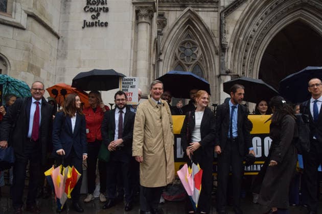 October 7, 2026, London, England, United Kingdom: Barrister and former Attorney General DOMINIC GRIEVE KC (centre) stands with the legal team and campaigners outside the Royal Courts of Justice as the legal case against the London Bullion Market Association begins. The LBMA is accused of incorrectly certifying gold from TanzaniaÃ¢â‚¬â ¢s North Mara mine as clean , despite reported human rights abuses connected to the mine. The case is being brought by the families of two Tanzanian men who were killed at the gold mine. London United Kingdom - ZUMAv130 20261007_zip_v130_006 Copyright: xVukxValcicx