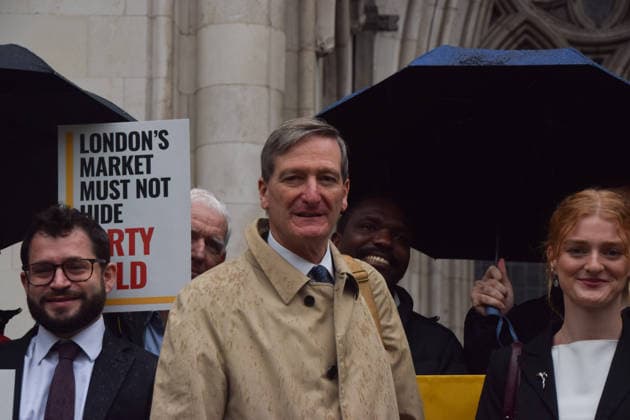 October 7, 2026, London, England, United Kingdom: Barrister and former Attorney General DOMINIC GRIEVE KC (centre) stands with the legal team and campaigners outside the Royal Courts of Justice as the legal case against the London Bullion Market Association begins. The LBMA is accused of incorrectly certifying gold from TanzaniaÃ¢â‚¬â ¢s North Mara mine as clean , despite reported human rights abuses connected to the mine. The case is being brought by the families of two Tanzanian men who were killed at the gold mine. London United Kingdom - ZUMAv130 20261007_zip_v130_008 Copyright: xVukxValcicx