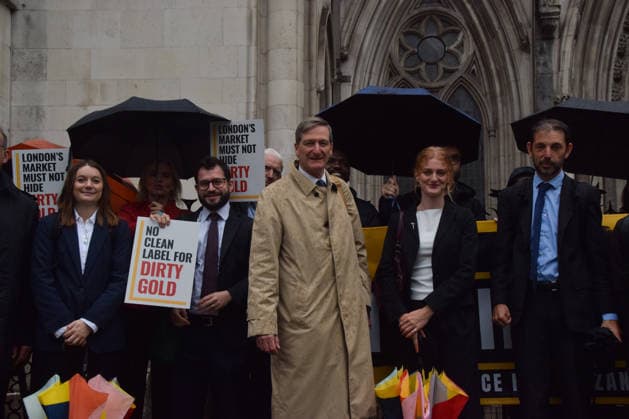 October 7, 2026, London, England, United Kingdom: Barrister and former Attorney General DOMINIC GRIEVE KC (centre) stands with the legal team and campaigners outside the Royal Courts of Justice as the legal case against the London Bullion Market Association begins. The LBMA is accused of incorrectly certifying gold from TanzaniaÃ¢â‚¬â ¢s North Mara mine as clean , despite reported human rights abuses connected to the mine. The case is being brought by the families of two Tanzanian men who were killed at the gold mine. London United Kingdom - ZUMAv130 20261007_zip_v130_009 Copyright: xVukxValcicx
