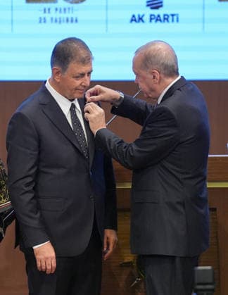 Legislative Year Opening Meeting with AK Party Deputies ANKARA, TURKIYE - OCTOBER 7: Turkish President and Leader of the Justice and Development (AK) Party Recep Tayyip Erdogan (R) pins the party badge on Izmir Metropolitan Municipality Mayor Cemil Tugay (L), who joined the AK Party, during the Legislative Year Opening Meeting with AK Party Deputies at the AK Party Congress Center in Ankara, Turkiye on October 7, 2026. Ercin Erturk Anadolu Ankara Turkey. Editorial use only. Please get in touch for any other usage.  Copyright: x2026xAnadoluxErcinxErturkx