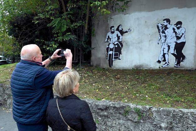 IPA89393692 - MILAN - October 7, 2026 - A mural by Alexandro Palombo, an artwork on display on October 7 at the Museum of Modern Art, located at 16 Via Palestro, dedicated to the young couple kidnapped during the attack on the Nova Music Festival  Copyright: xMaurizioxMaulex xMaurizioxMaulex IPA89393692