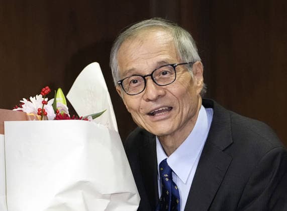Nobel chemistry prize co-winner Soai Kenso Soai, a professor emeritus at the Tokyo University of Science, receives a bouquet during a press conference at the university in Tokyo on Oct. 7, 2026, after receiving the 2026 Nobel Prize in Chemistry. Soai and French researcher Henri Kagan shared the prize for the discovery of non-linear effects and autocatalysis in asymmetric organic synthesis, the Royal Swedish Academy of Sciences said earlier in the day.  A14AA0005630365P