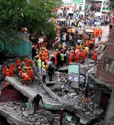 NEW DELHI, INDIA - OCTOBER 7: National Disaster Response Force (NDRF) jawans, Delhi Fire Service personnel, and local residents navigate heavy rubble during a search and rescue operation after a four-storey residential building collapsed in the New Seemapuri area of Shahdara on October 7, 2026, in New Delhi, India. The structural collapse occurred around 3:30 PM behind the local fish market, trapping multiple residents under concrete slabs and damaging two adjoining houses. At least one minor died while eight people were rescued and rushed to Rajiv Gandhi Super Speciality Hospital for emergency medical treatment as sniffer dogs and excavators worked late into the evening to locate remaining trapped survivors. (Photo by Ishant Chauhan Hindus