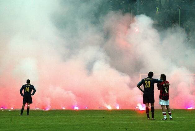 Spielabbruch in Mailand: Marco Materazzi (Inter, Mitte) und Rui Costa (Milan, re.) diskutieren gemeinsam über das von unbelehrbaren Inter Fans angerichtete Flammenmeer auf dem Spielfeld, daneben: Juan Sebastian Veron (Inter) Fußball EC 1 Herren Champions League 2004 2005, Viertelfinale, Internazionale FC Mailand - AC Mailand 0:1, Marko, Vdig Totale Unterbrechung, Spielunterbrechung, Diskussion, Mailand, Feuer, Flamme, Flammen