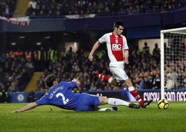 Chelsea s Branislav Ivanovic (L) tussles with Birmingham s Scott Dann , Barclays Premier League, Chelsea FC London - Birmingham City, 27th January, 2010 - EDITORIAL USE ONLY. No use with unauthorised audio, video, data, fixture lists, club league logos or live services. Online in-match use limited to 120 images, no video emulation. No use in betting, games or single club league player publications.
