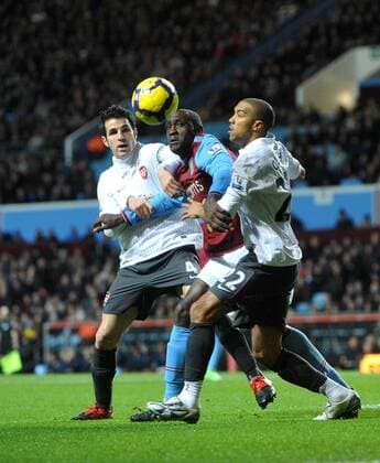 Emile Heskey (C) of Aston Villa is crowded out by Cesc Fabregas (L) and Gael Clichy of Arsenal , Barclays Premier League, Aston Villa - Arsenal FC London, 27th January, 2010 - EDITORIAL USE ONLY. No use with unauthorised audio, video, data, fixture lists, club league logos or live services. Online in-match use limited to 120 images, no video emulation. No use in betting, games or single club league player publications.