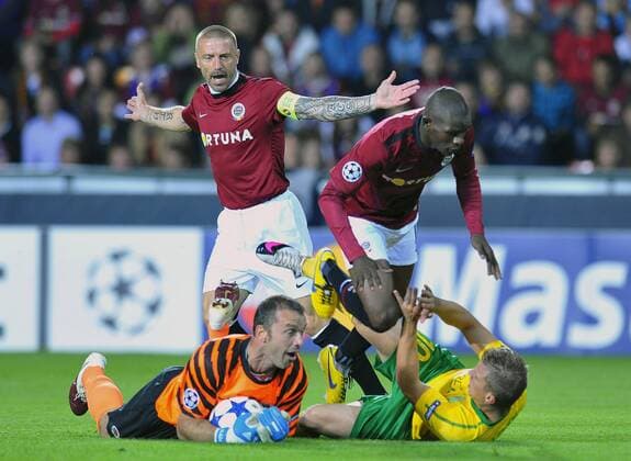 Players of Sparta Praha Tomas Repka, left, and Adiaba Bondoa, right, watch lying Sparta s goalie Jaromir Blazek, left, and Tomas Majtan of MSK Zilina, right, in their Champions League qualifying play-off first leg match in Prague Tuesday, Aug. 17, 2010. (CTKxPhoto KaterinaxSulova) CTKPhoto579201008170790401