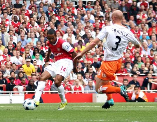 Arsenal s Theo Walcott scoring his sides opening goal Barclays Premier League Arsenal London (red) v Blackpool FC (white) 21st August, 2010 EDITORIAL USE ONLY. No use with unauthorised audio, video, data, fixture lists, club league logos or live services. Online in-match use limited to 120 images, no video emulation. No use in betting, games or single club league player publications.