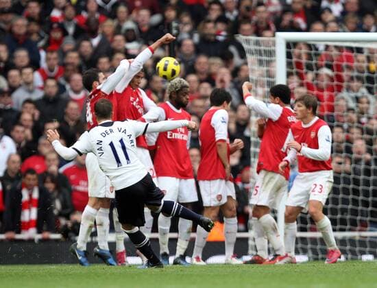 Arsenal FC London - Tottenham Hotspur - Rafael van der Vaart (Tottenham, front) takes a free-kick which hits Cesc Fabregas (L) arm to give a penalty.