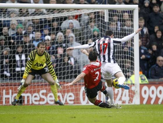 Gary Neville escapes censure following this challenge on Graham Dorrans which should have resulted in a penalty kick - Barclays Premier League, West Bromwich Albion (white) vs. Manchester United (red) 1st January, 2011 EDITORIAL USE ONLY. No use with unauthorised audio, video, data, fixture lists, club league logos or live services. Online in-match use limited to 120 images, no video emulation. No use in betting, games or single club league player publications. o0 Foulspiel, gefoult,