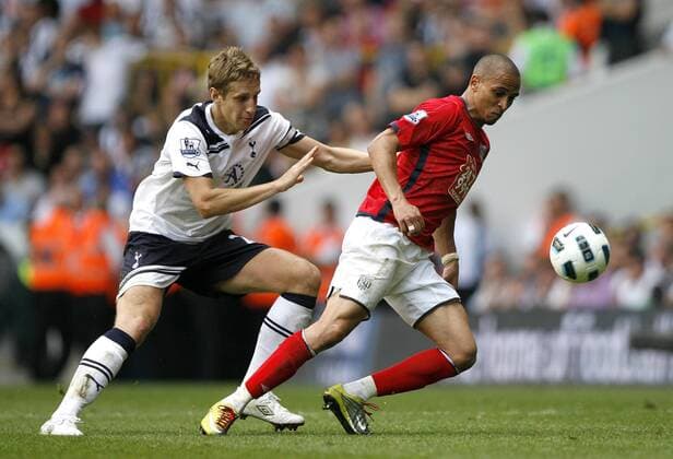 Peter Odemwingie of West Bromwich Albion holds off Michael Dawson of Tottenham Hotspur during the English Premier League football match between Tottenham Hotspur and West Bromwich Albion at White Hart Lane, London, England, on April 23, 2011. Barclays Premier League Tottenham Hotspur (white) v West Bromwich Albion (red) 23rd April, 2011 EDITORIAL USE ONLY. No use with unauthorised audio, video, data, fixture lists, club league logos or live services. Online in-match use limited to 120 images, no video emulation. No use in betting, games or single club league player publications.