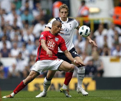 Peter Odemwingie of West Bromwich Albion holds off Michael Dawson of Tottenham Hotspur during the English Premier League football match between Tottenham Hotspur and West Bromwich Albion at White Hart Lane, London, England, on April 23, 2011. Barclays Premier League Tottenham Hotspur (white) v West Bromwich Albion (red) 23rd April, 2011 EDITORIAL USE ONLY. No use with unauthorised audio, video, data, fixture lists, club league logos or live services. Online in-match use limited to 120 images, no video emulation. No use in betting, games or single club league player publications.