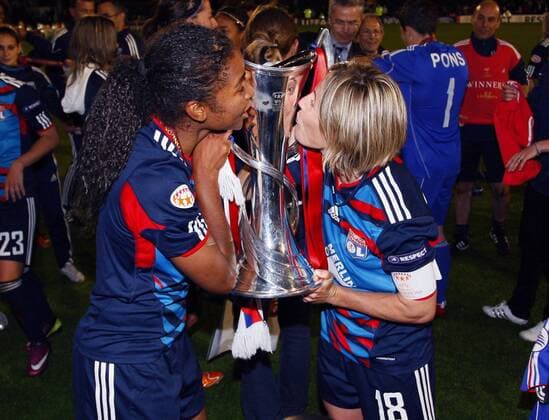 Laura Georges (L) and Sonia Bompastor of Olympique Lyonnais kiss the UEFA Women s Champions League trophy after the UEFA Women s Champions League final football match between Olympique Lyonnais and FFC Turbine Potsdam at Craven Cottage, London, England, on May 26, 2011. Photo Credit SPORTIMAGE JAKE BADGER UEFA Women s Champions League Final Olympique Lyonnais v Potsdam 26th May, 2011 EDITORIAL USE ONLY. No use with unauthorised audio, video, data, fixture lists, club league logos or live services. Online in-match use limited to 120 images, no video emulation. No use in betting, games or single club league player publications.