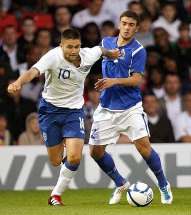 Henri Lansbury of England holds off Gara Garayev of Azerbaijan during the Under-21 Euro 2013 qualifying match between England and Azerbaijan at Vicarage Road, Watford, England, on September 1, 2011. Photo Credit SPORTIMAGE JAKE BADGER UEFA Under 21 Championship Qualifying England U21 v Azerbaijan U21 1st September, 2011 EDITORIAL USE ONLY. No use with unauthorised audio, video, data, fixture lists, club league logos or live services. Online in-match use limited to 120 images, no video emulation. No use in betting, games or single club league player publications.