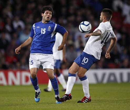 Amit Guluzada of Azerbaijan and Henri Lansbury of England fight for the ball during the Under-21 Euro 2013 qualifying match between England and Azerbaijan at Vicarage Road, Watford, England, on September 1, 2011. Photo Credit SPORTIMAGE JAKE BADGER UEFA Under 21 Championship Qualifying England U21 v Azerbaijan U21 1st September, 2011 EDITORIAL USE ONLY. No use with unauthorised audio, video, data, fixture lists, club league logos or live services. Online in-match use limited to 120 images, no video emulation. No use in betting, games or single club league player publications.