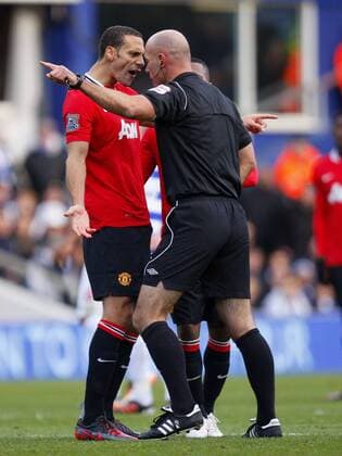 Rio Ferdinand of Manchester United clashes with referee Howard Webb during the Premier League match between Queens Park Rangers and Manchester United at Loftus Road, London, England, on December 18, 2011 Barclays Premier League QPR Queens Park Rangers vs Manchester United (ManU) 18th December, 2011 EDITORIAL USE ONLY. No use with unauthorised audio, video, data, fixture lists, club league logos or live services. Online in-match use limited to 120 images, no video emulation. No use in betting, games or single club league player publications.