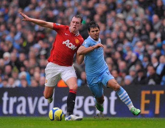 Phil Jones of Manchester United tussles with Sergio Kun Aguero of Manchester City The FA Cup with Budweiser 3rd Round Manchester City v Manchester Utd at the Etihad Stadium, Manchester. 8th January, 2012 EDITORIAL USE ONLY. No use with unauthorised audio, video, data, fixture lists, club league logos or live services. Online in-match use limited to 120 images, no video emulation. No use in betting, games or single club league player publications.