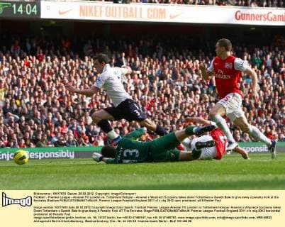 Football - Premier League - Arsenal FC London vs. Tottenham Hotspur - Arsenal s Wojciech Szczesny takes down Tottenham s Gareth Bale to give away a penalty kick at the Emirates Stadium