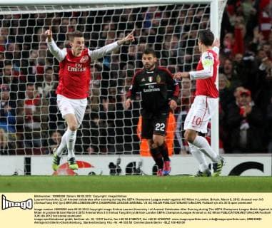 Laurent Koscielny (L) of Arsenal celebrates after scoring during the UEFA Champions League match against AC Milan in London, Britain, March 6, 2012. Arsenal won 3-0. (Xinhua Tang Shi) (jyc) BRITAIN-LONDON-UEFA CHAMPIONS LEAGUE-ARSENAL VS AC MILAN