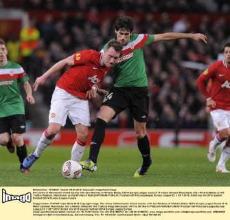 Phil Jones of Manchester United tussles with Javi Martinez of Athletic Bilbao..UEFA Europa League round of 16 match between Manchester Utd v Athletic Bilbao at Old Trafford Stadium, Manchester on the 8th March EDITORIAL USE ONLY. No use with unauthorised audio, video, data, fixture lists, club league logos or live services. Online in-match use limited to 120 images, no video emulation. No use in betting, games or single club league player publications.