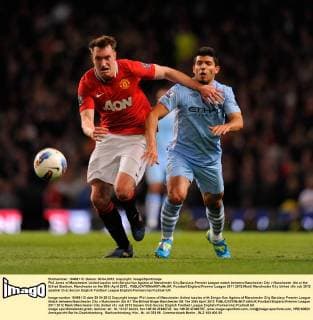 Phil Jones of Manchester United tussles with Sergio Kun Agüero of Manchester City.Barclays Premier League match between Manchester City v Manchester Utd at the Etihad Stadium, Manchester on the 30th April 2012.. EDITORIAL USE ONLY. No use with unauthorised audio, video, data, fixture lists, club league logos or live services. Online in-match use limited to 120 images, no video emulation. No use in betting, games or single club league player publications.