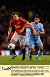 Phil Jones of Manchester United tussles with Sergio Kun Agüero of Manchester City.Barclays Premier League match between Manchester City v Manchester Utd at the Etihad Stadium, Manchester on the 30th April 2012.. EDITORIAL USE ONLY. No use with unauthorised audio, video, data, fixture lists, club league logos or live services. Online in-match use limited to 120 images, no video emulation. No use in betting, games or single club league player publications.