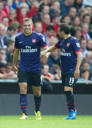 Football - Liverpool v Arsenal - Barclays Premier League - Anfield Stadium - Season 12 13 - 2 9 12 .Lucas Podolski of Arsenal celebrates scoring with Santi Cazorla of Arsenal.Mandatory Credit: Simon Bellis Sportimage.EDITORIAL USE ONLY. No use with unaurthorized audio, video, data, fixture lists, club league logos or ?live? services. Online in-match use limited to 45 images, no video emulation. No use in betting, games or single club league player publications. Please contact your account representative for further details... EDITORIAL USE ONLY. No use with unauthorised audio, video, data, fixture lists, club league logos or live services. Online in-match use limited to 120 images, no video emulation. No use in betting, games or single club league player publications.