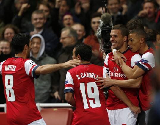 Arsenal s Lukas Podolski celebrates scoring his sides second goal..Football - Champions League Matchday 2 - Emirates Stadium, London - 3 10 12EDITORIAL USE ONLY. EDITORIAL USE ONLY. No use with unauthorised audio, video, data, fixture lists, club league logos or live services. Online in-match use limited to 120 images, no video emulation. No use in betting, games or single club league player publications.