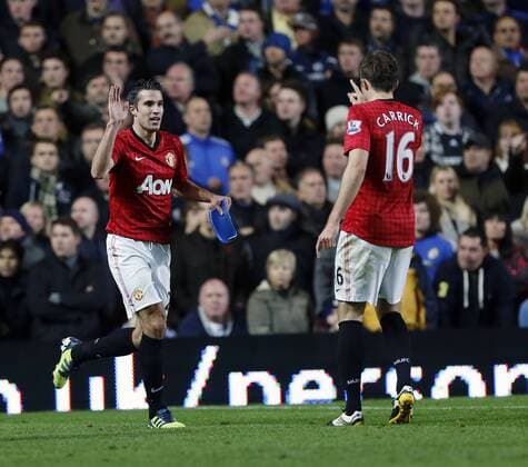 Manchester United s Robin Van Persie celebrates his sides third goal with part of a seat thrown on the pitch -- Chelsea FC London vs. Manchester United (ManU) - Barclays Premier League - Stamford Bridge, London- 28 10 12 - xDavidxKlein Sportimage EDITORIAL USE ONLY. No use with unauthorised audio, video, data, fixture lists, club league logos or live services. Online in-match use limited to 120 images, no video emulation. No use in betting, games or single club league player publications.