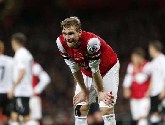 Arsenal s Per Mertesacker looks on dejected.. - FC Arsenal vs FC Fulham - Premier League- Emirates Stadium, London- 10 11 12 - PicturexDavidxKlein xSportimage EDITORIAL USE ONLY. No use with unauthorised audio, video, data, fixture lists, club league logos or live services. Online in-match use limited to 120 images, no video emulation. No use in betting, games or single club league player publications.