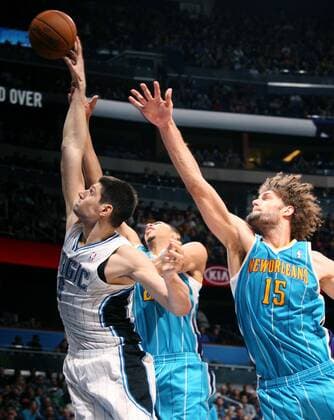 Dec. 26, 2012 - Orlando, FL, USA - The Orlando Magic s Nikola Vucevic, left, drives in front of the New Orleans Hornets Anthony Davis and Robin Lopez (15) at the Amway Center in Orlando, Florida, on Wednesday, December 26, 2012. New Orleans won, 97-94. New Orleans at Orlando - ZUMAm67