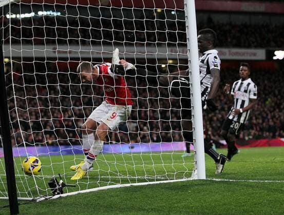 Arsenal s Lukas Podolski scoring his sides third goal..- Arsenal v Newcastle United - Barclays Premier League - the Emirates Stadium, London- 29 12 12 - Picture David Klein Sportimage EDITORIAL USE ONLY. No use with unauthorised audio, video, data, fixture lists, club league logos or live services. Online in-match use limited to 120 images, no video emulation. No use in betting, games or single club league player publications.