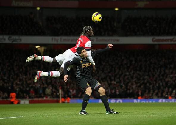 Arsenal s Bacary Sagna tussles with Liverpool s Luis Suarez.. - FC Arsenal vs FC Liverpool - Barclays Premier League - Emirates Stadium, London- 30 01 13 - EDITORIAL USE ONLY. No use with unauthorised audio, video, data, fixture lists, club league logos or live services. Online in-match use limited to 120 images, no video emulation. No use in betting, games or single club league player publications.
