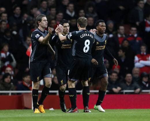 Liverpool s Luis Suarez celebrates scoring his sides opening goal.. - FC Arsenal vs FC Liverpool - Barclays Premier League - Emirates Stadium, London- 30 01 13 - EDITORIAL USE ONLY. No use with unauthorised audio, video, data, fixture lists, club league logos or live services. Online in-match use limited to 120 images, no video emulation. No use in betting, games or single club league player publications.