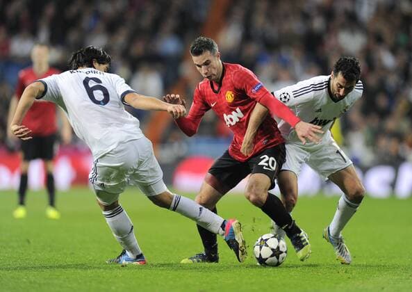 Robin van Persie of Manchester United tussled with Sami Khedira of Real Madrid and Alvaro Arbeloa of Real Madrid - UEFA Champions League First Knockout Round 1st leg - Real Madrid vs Manchester Utd - Bernabau Stadium - Madrid - 13 11 12 - - EDITORIAL USE ONLY. No use with unauthorised audio, video, data, fixture lists, club league logos or live services. Online in-match use limited to 120 images, no video emulation. No use in betting, games or single club league player publications.