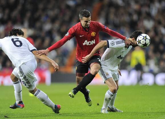 Robin van Persie of Manchester United tussled with Sami Khedira of Real Madrid and Alvaro Arbeloa of Real Madrid - UEFA Champions League First Knockout Round 1st leg - Real Madrid vs Manchester Utd - Bernabau Stadium - Madrid - 13 11 12 - - EDITORIAL USE ONLY. No use with unauthorised audio, video, data, fixture lists, club league logos or live services. Online in-match use limited to 120 images, no video emulation. No use in betting, games or single club league player publications.